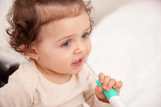 Baby brushing teeth with BabySonic kids Electric Toothbrush
