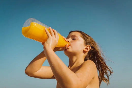 Child drinking delicious sugary orange flavoured drink | brush baby toothbrushes and infant toothpaste